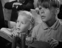 Georges Poujouly and Brigitte Fossey as Paulette and her protector Michel